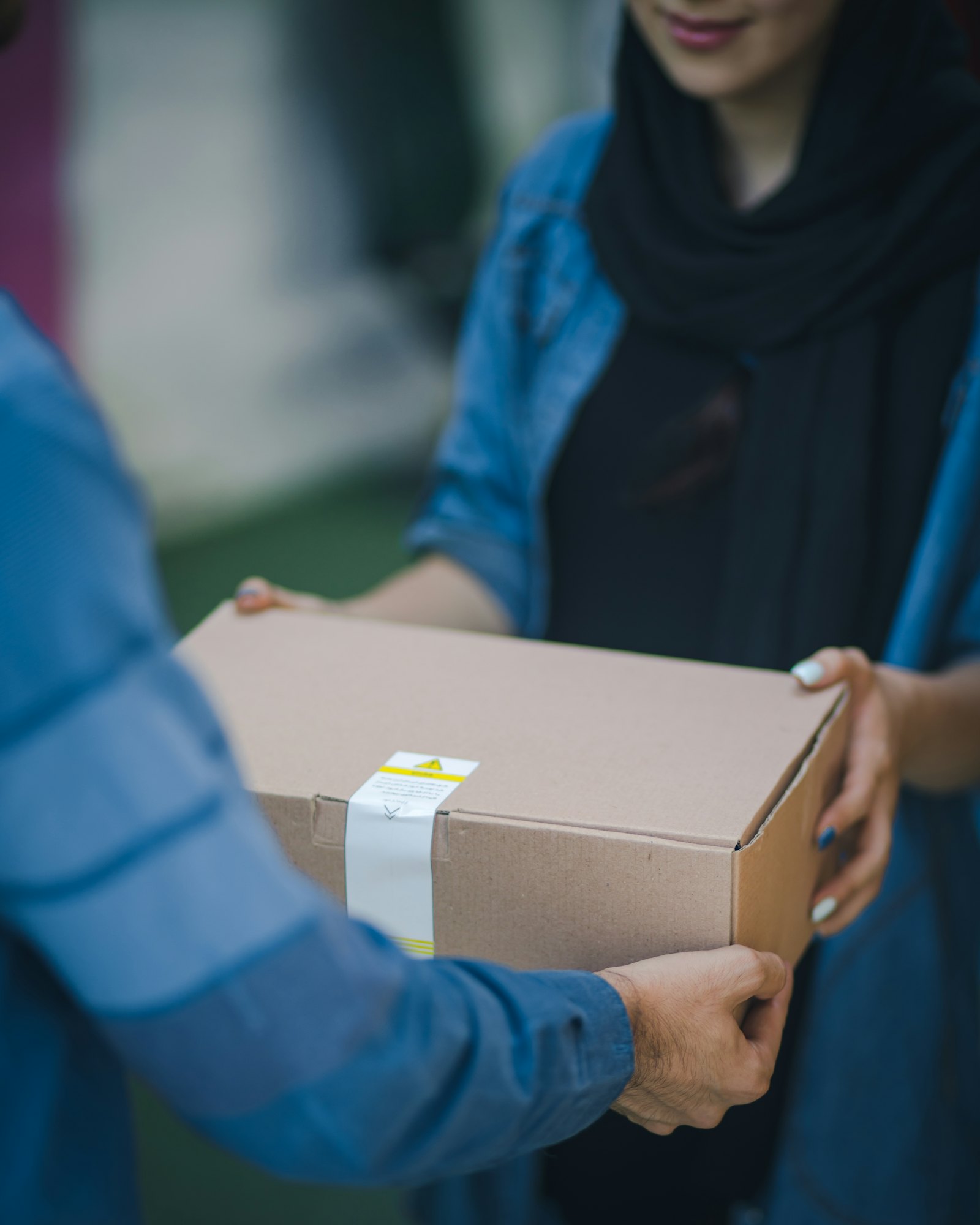 Parcels being packed and labelled at a logistics station